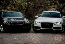 Czarne BMW i białe Audi sedan zaparkowane na żwirowej drodze outdoors