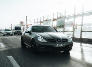 Czarny Mercedes-Benz jadący ruchliwą miejską ulicą w dzień